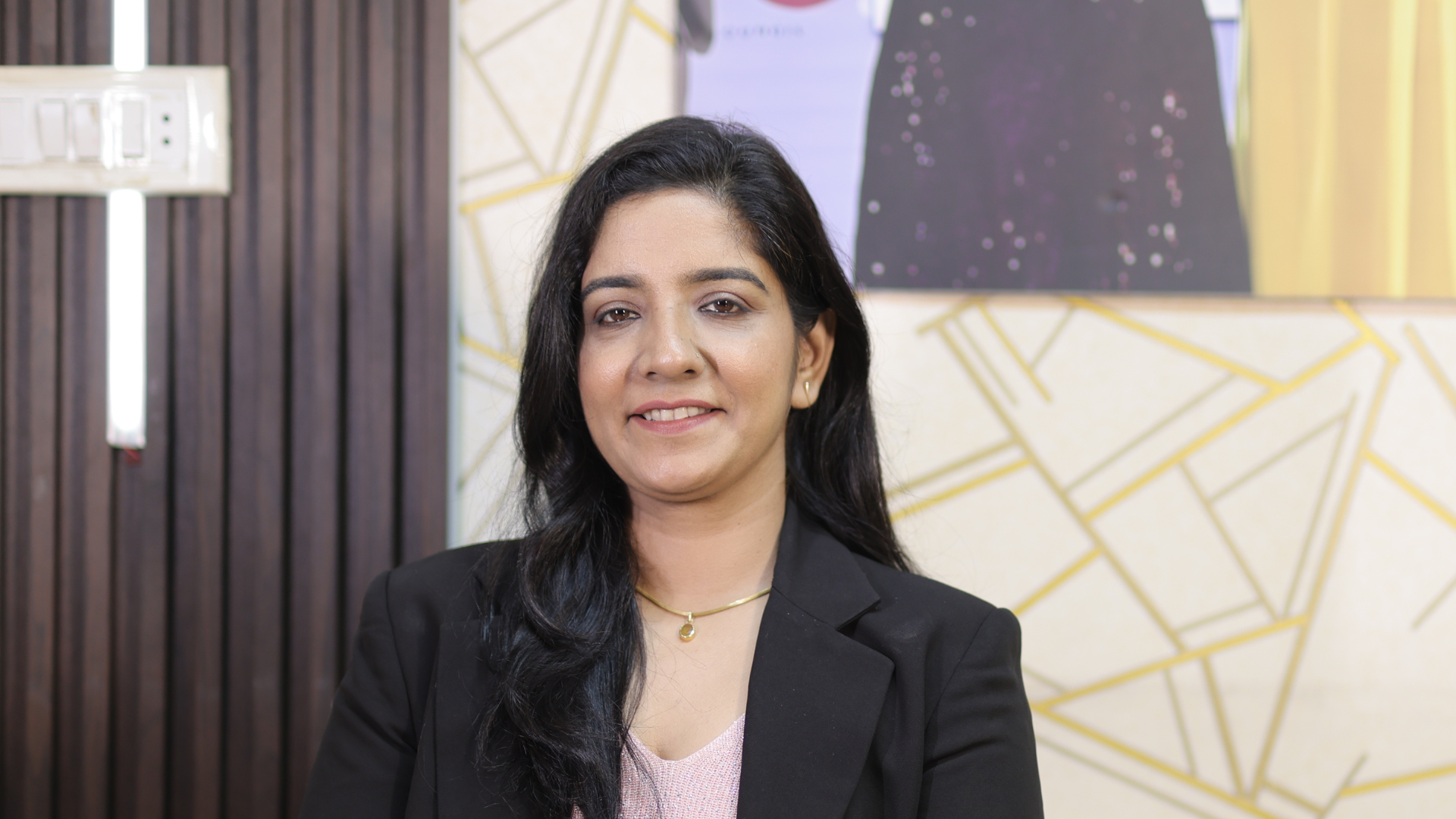 Soniya, professional makeup artist, holding an eyeshadow palette in her studio